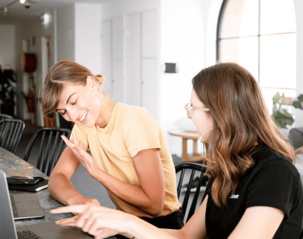 Two Women Collaborating in front of a Laptop