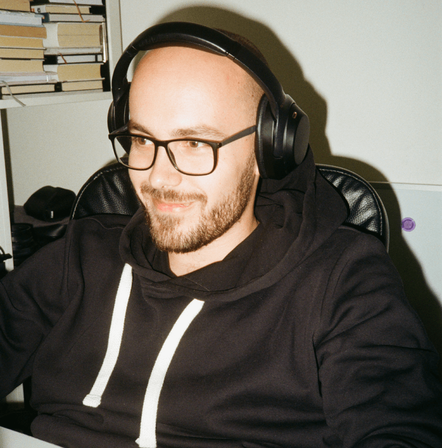 Guy With Headset and Glasses Typing on His Keyboard