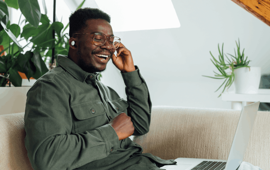 man on couch with computer