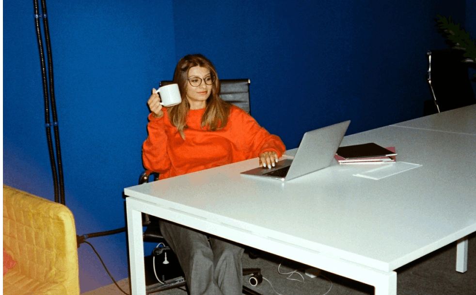 young woman orange crewneck