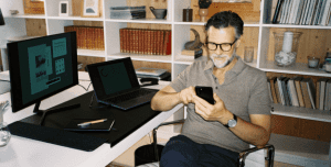 man at home office with phone