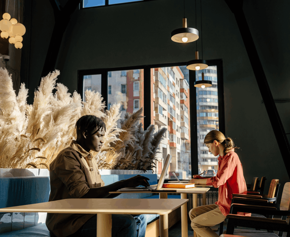 two people sitting in a modern office working