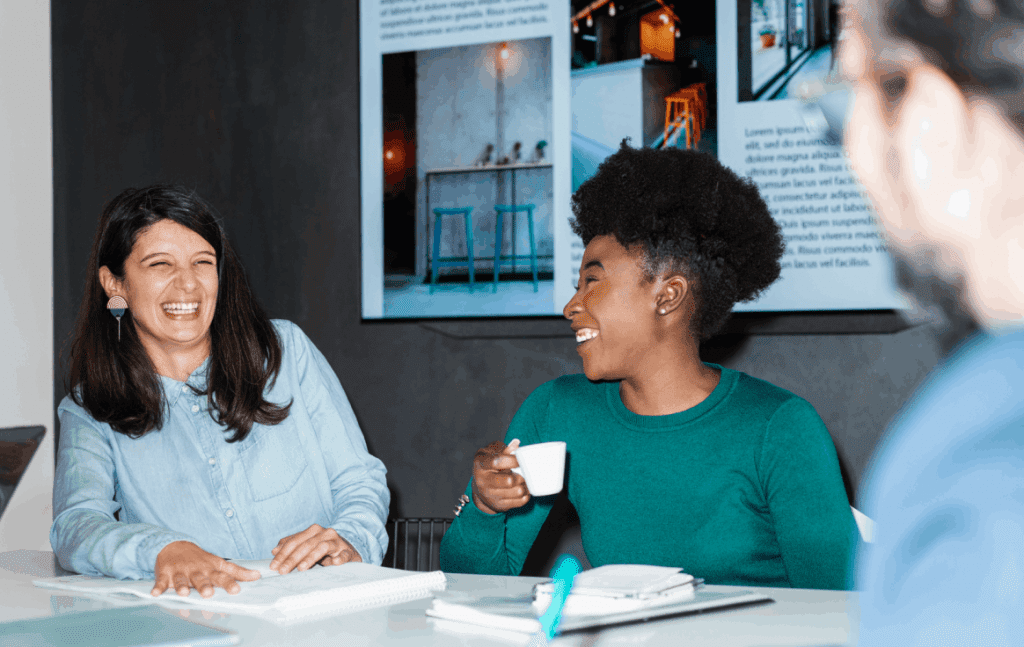 two women lauging at an office desk 1024x647 1 - Nets